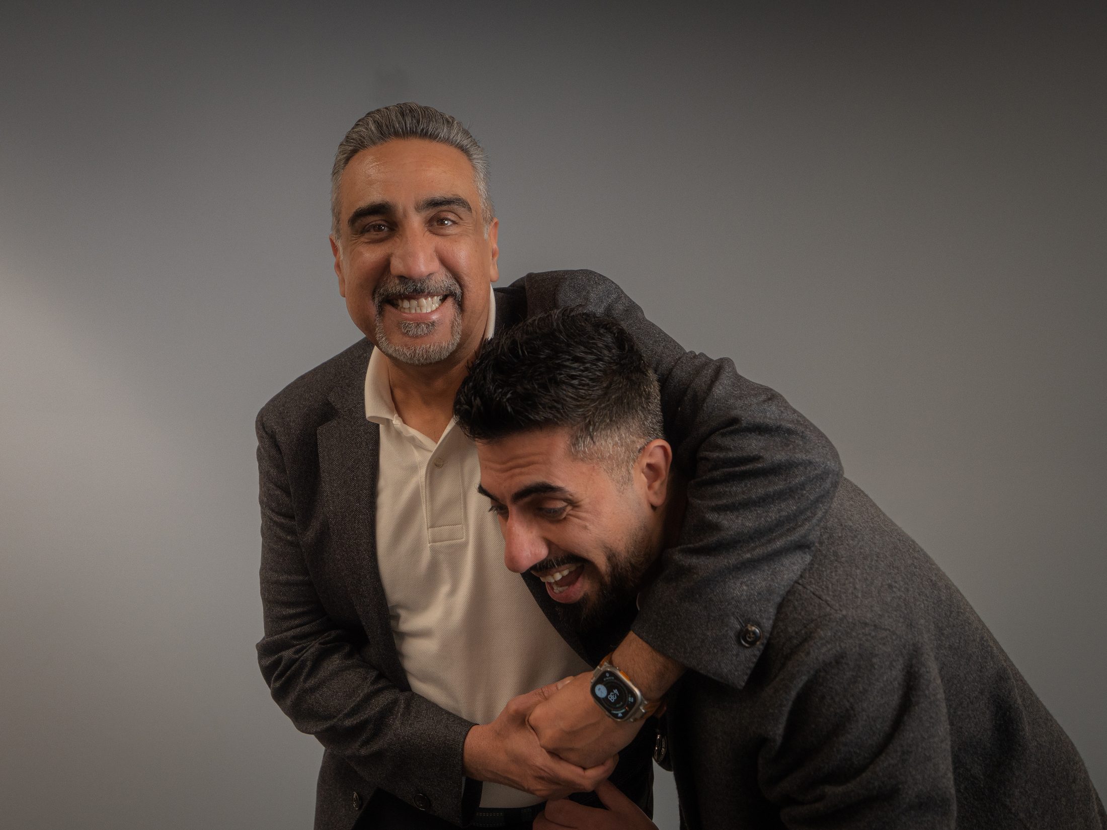 Matt and Richi laughing together, Matt's arm around Richi's shoulders