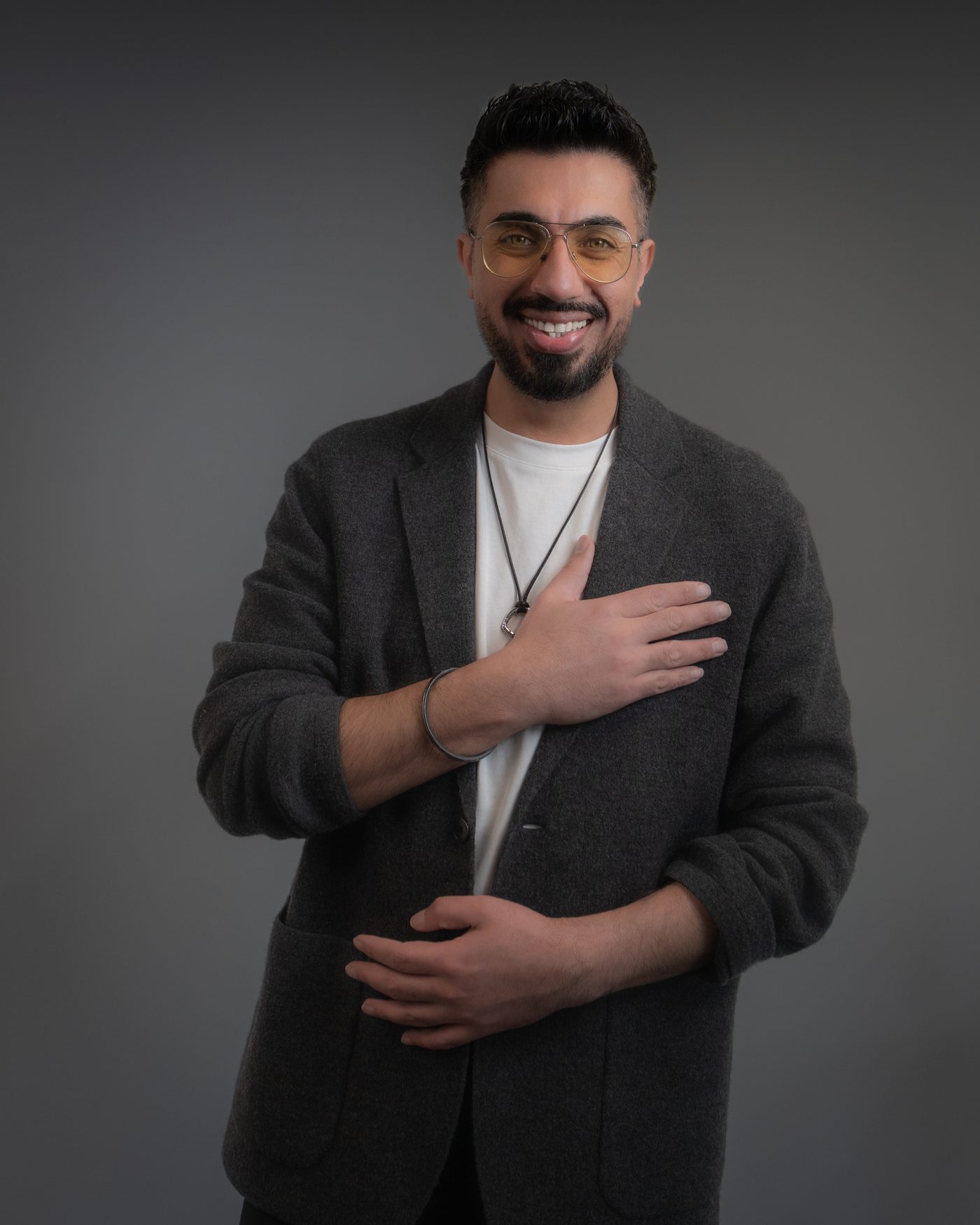 Portrait of Richi Pal smiling with a hand on his chest